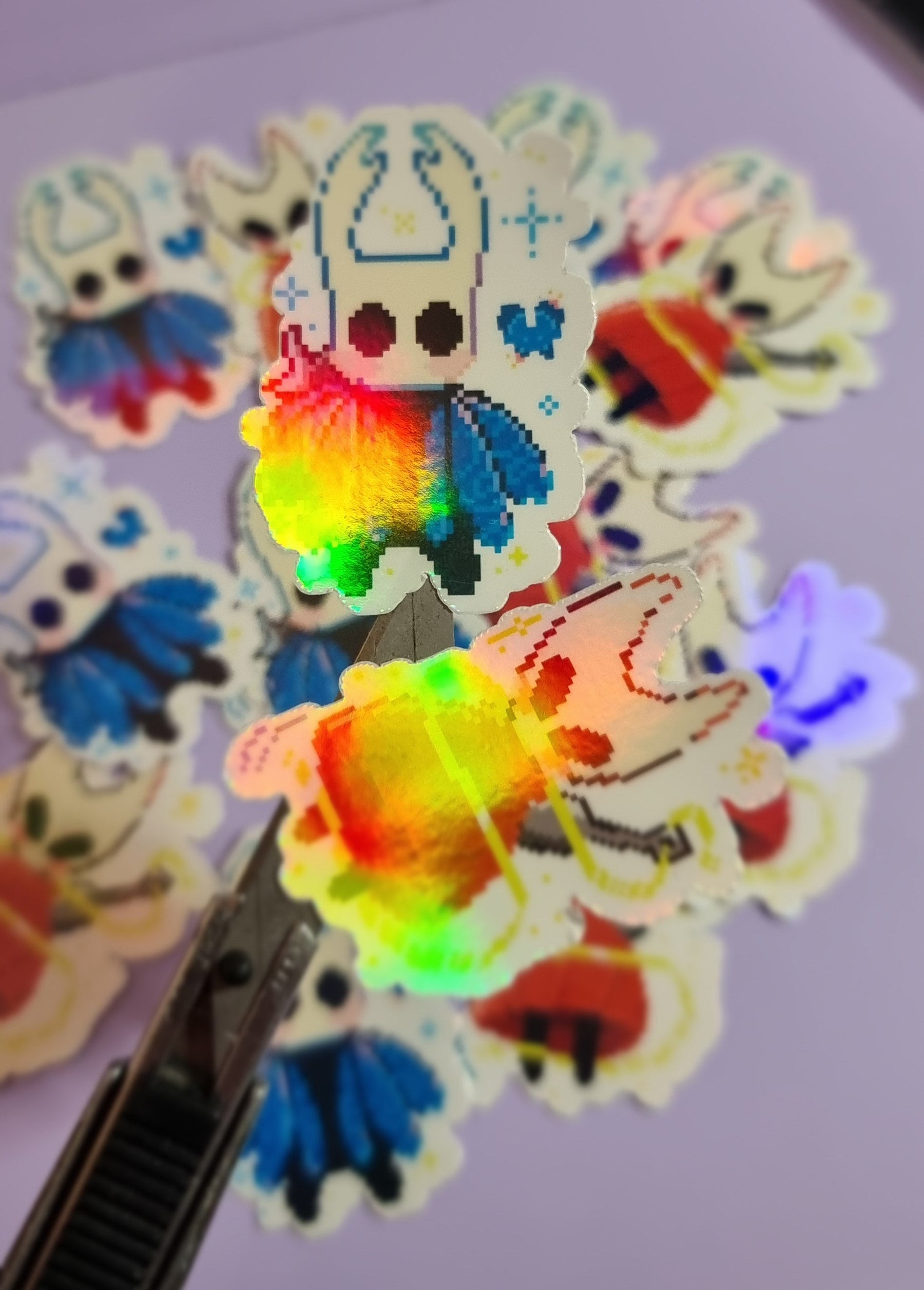 Colorful cartoon stickers on a white surface with a pen.