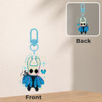 Keychain with character design on front and back, on a neutral background