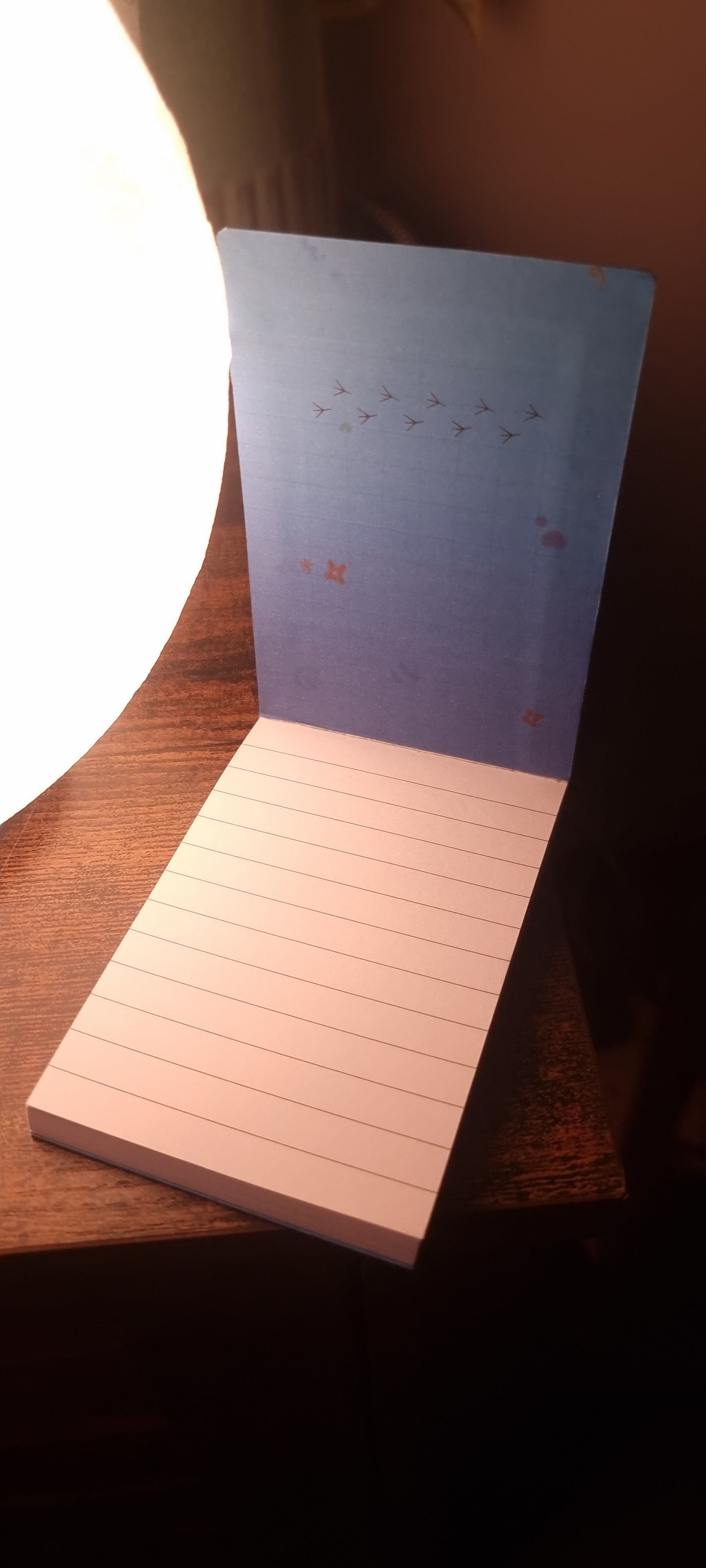 Notebook with lined pages on a wooden surface